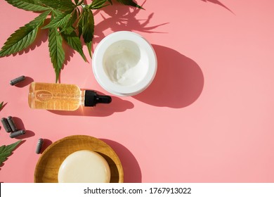 Cannabis CBD Oil And Hemp Products On Pink Background. Herbal Organic Medicine Product.