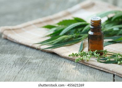 cannabis essential oil container with cannabis leaves and cannabis seeds