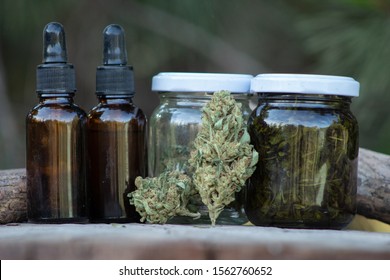 Cannabis indica bud, concentrates and extractions, from a high cbd strain. Both are alcohol extracts, the one on the right is made from buds and leaves, and the droppers contain pure diluted hashish.