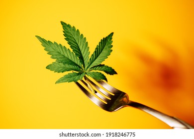 Cannabis Leaf On Fork. Cooking Marijuana Edibles. CBD Oil Food. 