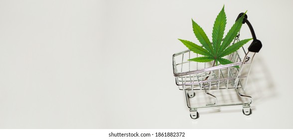 Cannabis Leaf In Shopping Cart Banner. Medical Weed. Fast Marijuana Delivery. Copy Space. White Background