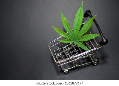 Cannabis Leaf In Shopping Cart. Medical Weed. Fast Marijuana Delivery. Copy Space. Black Background 