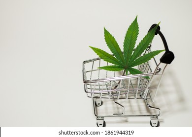 Cannabis Leaf In Shopping Cart. Medical Weed. Fast Marijuana Delivery. Copy Space. White Background 