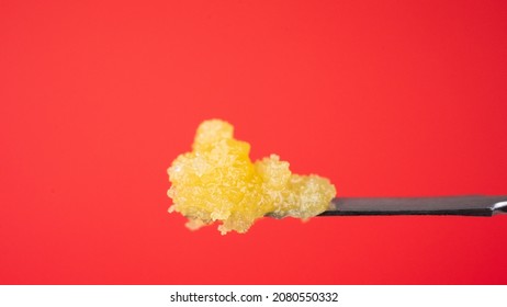 Cannabis Live Resin Marijuana Oil Concentrate on Red Background