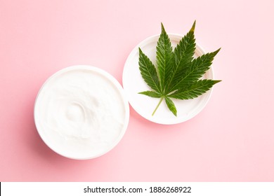 Cannabis Lotion Topical With Marijuana Leaf And Lid On Pink Background