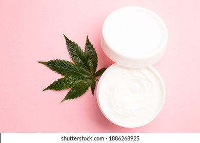 Cannabis Lotion Topical With Marijuana Leaf And Lid On Pink Background