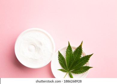 Cannabis Lotion Topical With Marijuana Leaf And Lid On Pink Background