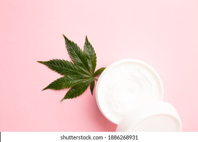 Cannabis Lotion Topical With Marijuana Leaf And Lid On Pink Background