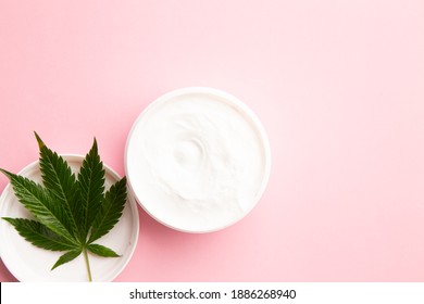 Cannabis Lotion Topical With Marijuana Leaf And Lid On Pink Background