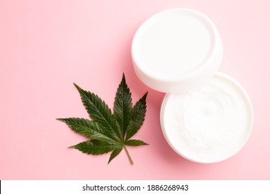 Cannabis Lotion Topical With Marijuana Leaf And Lid On Pink Background