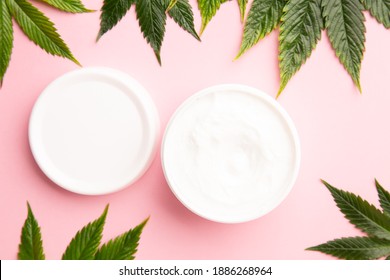 Cannabis Lotion Topical With Marijuana Leaf And Lid On Pink Background