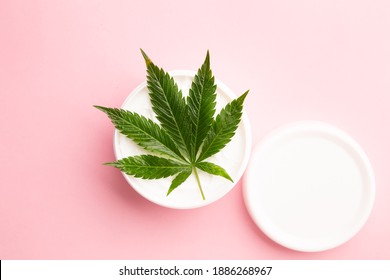 Cannabis Lotion Topical With Marijuana Leaf And Lid On Pink Background