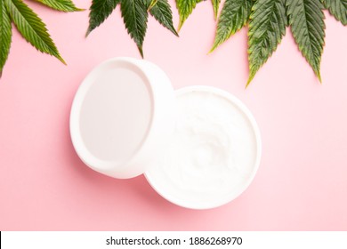 Cannabis Lotion Topical With Marijuana Leaf And Lid On Pink Background