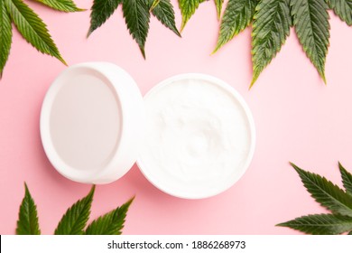 Cannabis Lotion Topical With Marijuana Leaf And Lid On Pink Background