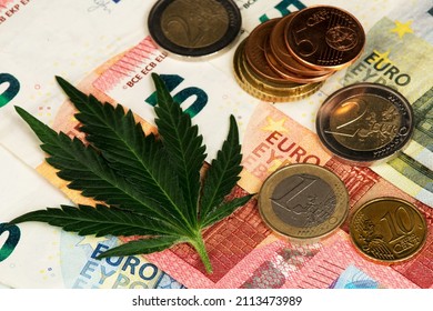 Cannabis Medical Marijuana Leaf with Euro coins and Euro Banknotes. Cannabis Medical Marijuana Business Concept. € Euro Dollar Marijuana Cannabis CBD Hemp Stock Market Europe