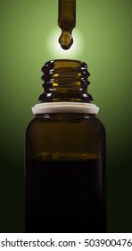 Cannabis Oil Being Droped Into A Bottle.