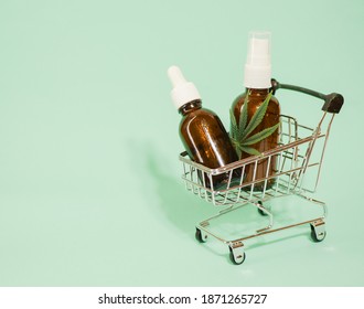 Cannabis Oil Bottles In Shopping Cart. Marijuana Leaf. Online Weed Store. CBD Oil. Alternative Medicine 