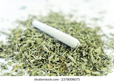 Cannabis are on white table. Marijuana bob close up. Cannabis in white paper. BMPCC. Marijuana, weed, drug smoking concept. CBD, THC. Preparing cannabis for consumption. legalization of light drugs.