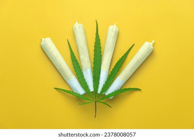 Cannabis are on yellow table. Marijuana bob close up. Cannabis in white paper. BMPCC. Marijuana, weed, drug smoking concept. CBD, THC. Preparing cannabis for consumption. legalization of light drugs.