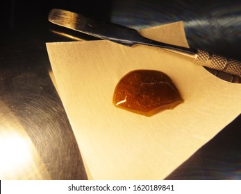 Cannabis Rosin on Parchment with Dab Tool