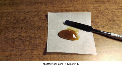 Cannabis Rosin On Parchment Paper With Dab Tool