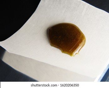 Cannabis Rosin on Parchment Paper on Metal Table