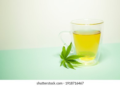 Cannabis Tea In Transparent Cup. Medical Marijuana Leaf. Homeopathic Herb. Stress Relief Therapy. Copy Space