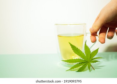 Cannabis Tea In Transparent Cup. Medical Marijuana Leaf. Homeopathic Herb. Stress Relief Therapy 