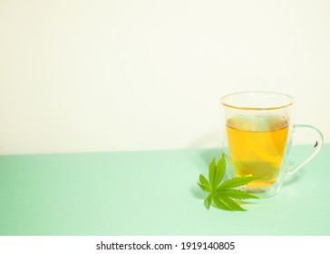 Cannabis Tea In Transparent Cup. Medical Marijuana Leaf. Homeopathic Herb. Stress Relief Therapy 