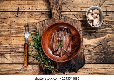 Canned Anchovies Fish Fillet In A Wooden Bowl. Wooden Background. Top View