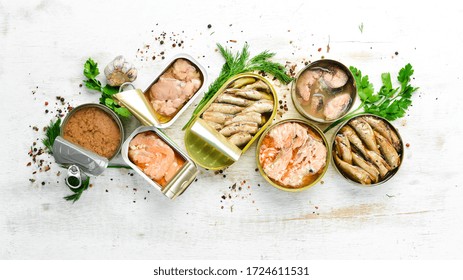 Canned Fish In Tin Cans: Salmon, Tuna, Mackerel And Sprats. Top View. Free Space For Your Text.