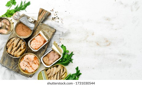 Canned Fish In Tin Cans: Salmon, Tuna, Mackerel And Sprats. Top View. Free Space For Your Text.