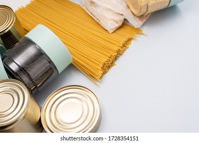 Canned food, pasta, groats and pasta on a blue background. Donates for low-income families during the coronavirus - Shutterstock ID 1728354151