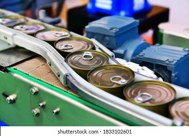 Canned Food Products On Conveyor Belt In Distribution Warehouse. Parcels Transportation System Concept