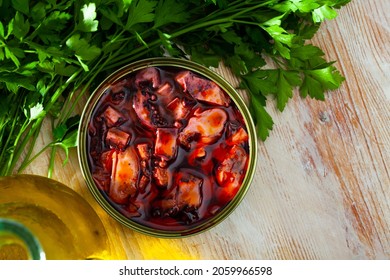 Canned Giant Squid Tentacles In Red Sauce Served On Wooden Table