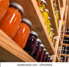 Canned Goods On Wooden Storage Shelves In Pantry