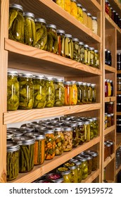 Canned Goods On Wooden Storage Shelves In Pantry