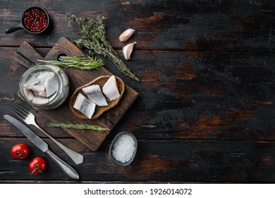 Canned Herring , Fish Preserves Set, On Wooden Cutting Board, On Old Dark Wooden Table Background With Herbs And Ingredients, Top View Flat Lay, With Copyspace And Space For Text