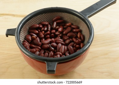 Canned Kidney Beans In Strainer To Drain After Rinsing With Water To Reduce Sodium