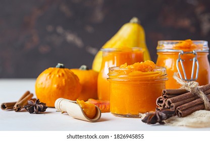 Canned Organic Pumpkin Puree In Glass Jar With Fresh Pumpkin, Cinnamon And Anise On Light Background. Ingredient For Thanksgiving, Autumn Or Winter Recipes.