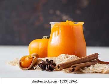 Canned Organic Pumpkin Puree In Glass Jar With Fresh Pumpkin, Cinnamon And Anise On Light Background. Ingredient For Thanksgiving, Autumn Or Winter Recipes.