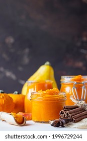 Canned Organic Pumpkin Puree In Glass Jar With Fresh Pumpkin, Cinnamon And Anise. Ingredient For Thanksgiving, Autumn Or Winter Recipes.