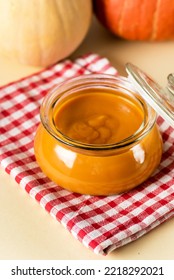 Canned Organic Pumpkin Puree In Glass Jar With Fresh Pumpkin Napkin Yellow Background Thanksgiving Autumn Or Winter Recipes Vertical