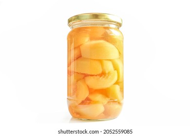 Canned peaches in glass jar isolated on white background. Compote made of sliced fruit halves