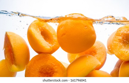 Canned peaches. Peach fruit splash in water
