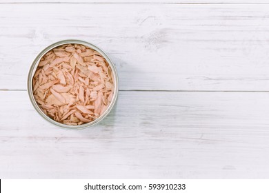 Canned Tuna On Wooden Table