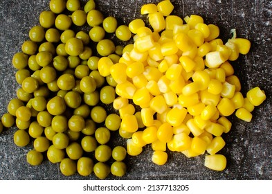 Canned Veggies, Corn, Green Peas, On A Dark Background. Top View. Close-up.