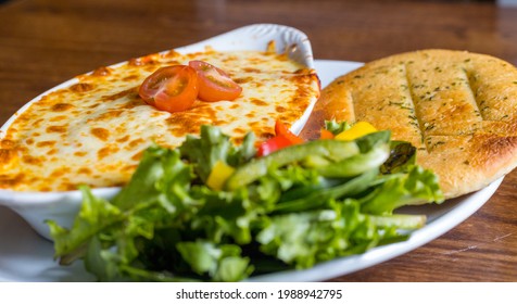 Cannelloni With Garlic Flatbread And Salad - Side View - Shallow Focus