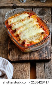 Cannelloni Pasta Tubes Packed With A Chees And Chicken Filling, Topped With A Tomato Sauce.