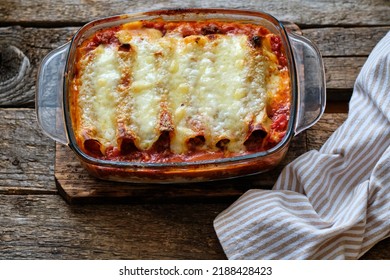 Cannelloni Pasta Tubes Packed With A Chees And Chicken Filling, Topped With A Tomato Sauce.